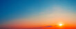 Panorama of dramatic sunset sky with setting sun