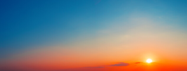 Wall Mural - panorama of dramatic sunset sky with setting sun