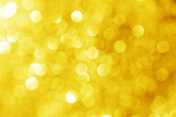 abstract defocused yellow bokeh sparkling light glitter background. for wallpaper backdrop and template.