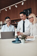 © Flamingo Images - Smiling group of businesspeople working together at an office ta