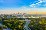 Beautiful panoramic aerial drone view to the Center of modern Warsaw city with silhouettes of skyscrapers in in the rays