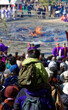 View from behind a boy on an adult's shoulders watching the Mount Takao fire-walking ceremony