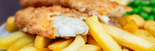 Traditional English Food Such As Fish And Chips With Green Peas Served In The Pub Or Restaurant