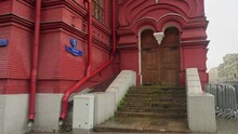 Red Building With Stairs Leading To Door And Writing On The Wall Meaning Adress Red Square 1