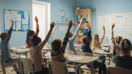 Poster - Caring Teacher Explains Lesson to a Classroom Full of Bright Diverse Children. In Elementary School with Group of Smart Multiethnic Kids Learning Science, Whole Classroom Raising Hands Knowing Answer