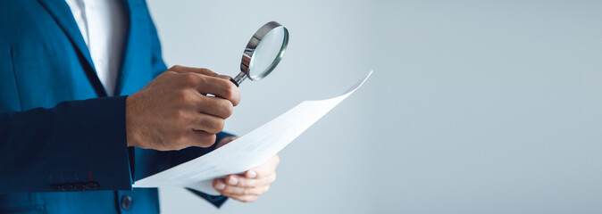 man hand magnifier and document