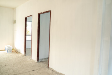 Poster - Empty room under construction in a new house,House door under construction.