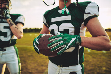 Wall Mural - American football quarterback standing on a field with his team