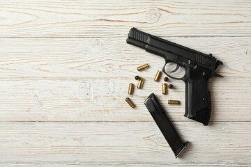 Wall Mural - Pistol, bullets and magazine on wooden background