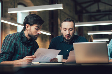 Clever young entrepreneurs working on their company development