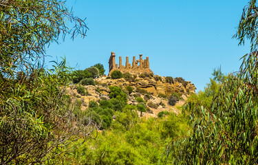 The Temple of Juno in the ancient Sicilian city of Agrigento viewed from the base of city ridge in summer