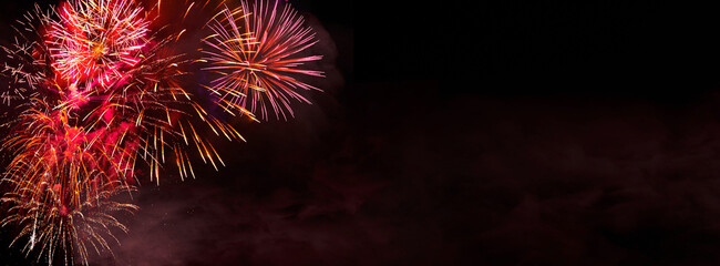 Wall Mural - fireworks, colorful sylvester-fireworks on black background with coloured accent