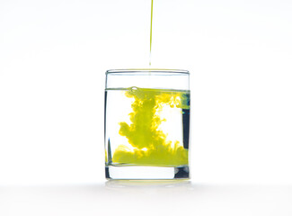 Yellow ink in water, color abstraction, color explosion in a glass.