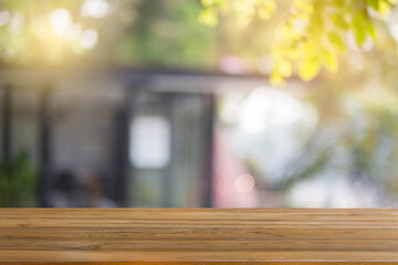 Brown wooden table in the garden background, display for product.