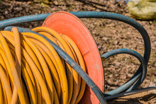 Yellow Spooled Power Cord At Building Site.