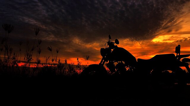 Fototapete - Motorcycle silhouette at sunset time