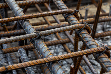 Rebar tie wire work at construction site. Steel bars reinforcing for reinforced concrete and building structures.