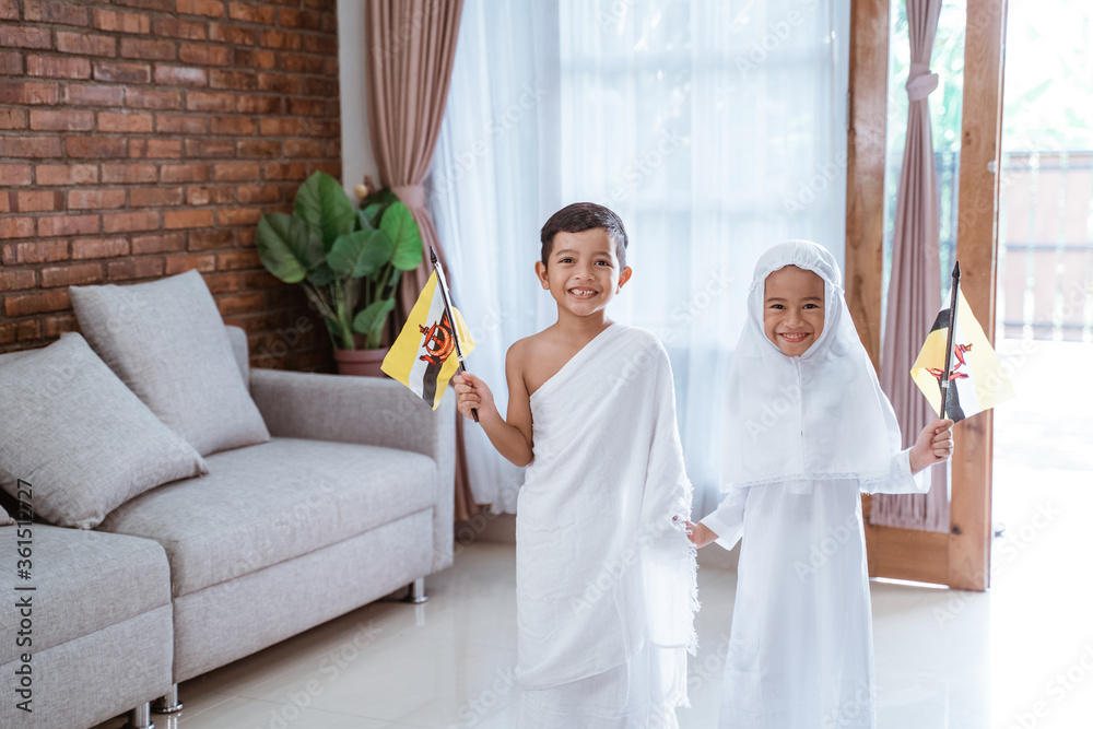 cute little kid wearing muslim ihram clothes and dress. hajj and umrah ...