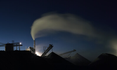 Wall Mural - Rock stone crushing equipment working at night under artificial lighting, panorama.