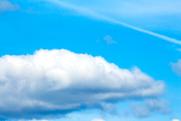 a large white cloud against a blue sky