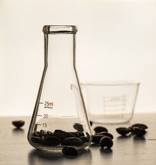 Canvas Print - Close up shot of coffee beans in laboratory glassware being tested