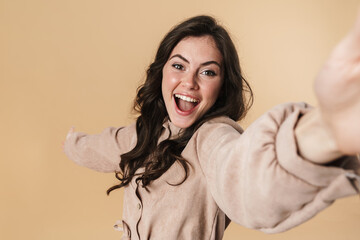 Sticker - Image of cheerful cute woman laughing and taking selfie photo