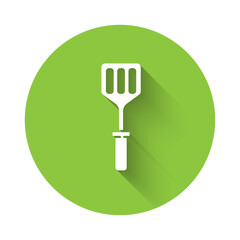 Sticker - White Spatula icon isolated with long shadow. Kitchen spatula icon. BBQ spatula sign. Barbecue and grill tool. Green circle button. Vector Illustration.