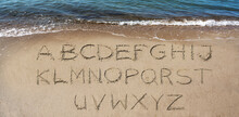 Alphabeth Handwritten In The Sand On The Beach To Make Your Own Text