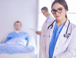 Female doctor using tablet computer in hospital lobby