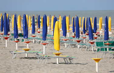 Wall Mural - closed umbrellas in the bathhouse without people because there i