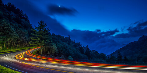 Car zooming through Great Smoky Mountains National Park at night.