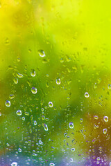  Raindrops on the glass. rainy green window in summer. abstract natural look. rainy season. drops on the glass. Vertical photo for background.