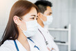 © Have a nice day  - Medical healthcare two Asian doctor colleague teamwork working together examine diagnosing discuss arm crossed wearing surgical mask stethoscope work at home modern office white isolated background