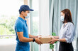 © Have a nice day  - Deliveryman delivering package box parcel giving to female customer at home wearing face mask safety coronavirus covid-19 infection customer delivery service logistics ordering mail posting business