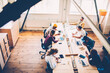 © BullRun - Top view of male and female members of crew sitting at desktop using technologies during working process,group of skilled developers concentrated on task cooperating and discussing ideas using laptops