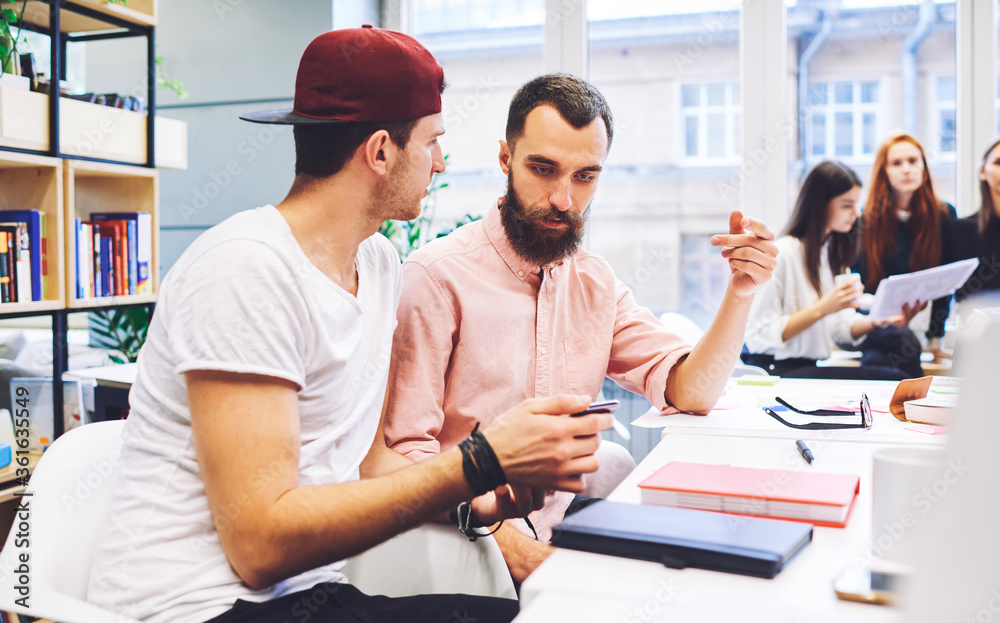 Business couch checking students task watching video about advertising ...