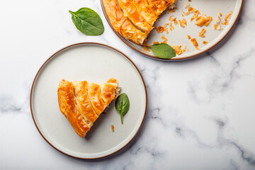 Wall Mural - Filo Spinach and Feta Twist Pie in the iron pan after oven. Authentic Greek bakery. With spinach, mizithra and feta cheeses.