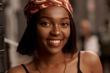 Closeup breast outdoor portrait of young beautiful african woman in black shirt. Trendy lifestyle girl looking at you.