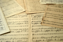 Old Sheets With Music Notes Scattered On The Table. Close-up. Retro Style. Selective Focus.
