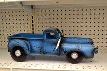 A Blue Truck Available For Purchase Inside Of A Retail Store