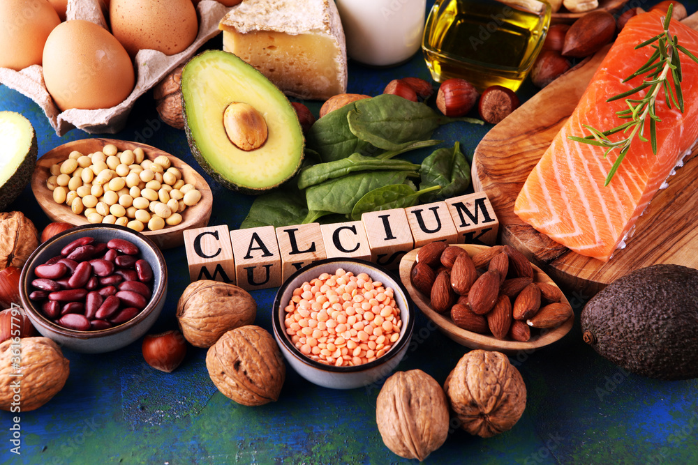 Best Calcium Rich Foods Sources. Healthy eating. Foods rich in calcium such as bean, almonds, hazelnuts, spinach leaves, cheese, and fresh milk - obrazy, fototapety, plakaty 
