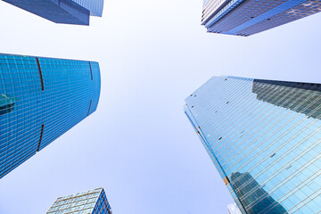 Modern skyscraper in Shanghai, with blue sky in the back.