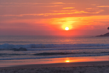 .The sun fell on the horizon in the sea at Karon beach Phuket.