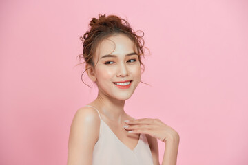 Wall Mural - Amazed young Asian woman with clean fresh skin. Over pink background.