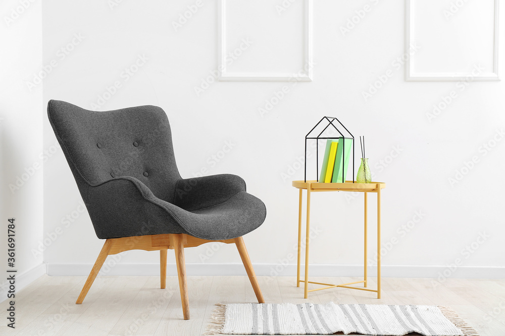 Interior of modern room with armchair and table