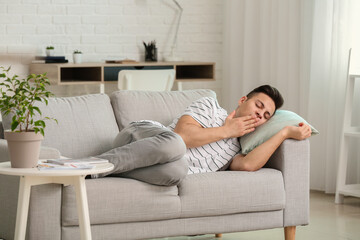 Canvas Print - Young man suffering from sleep deprivation at home