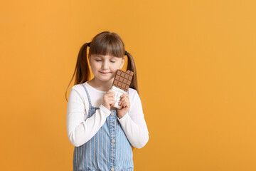 Wall Mural - Cute funny girl with chocolate on color background