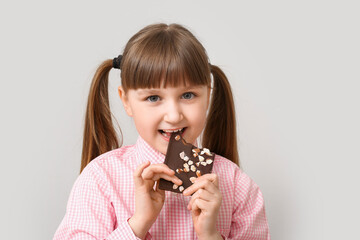 Sticker - Cute funny girl with chocolate on light background