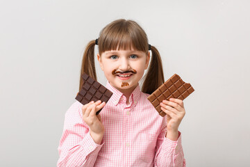 Poster - Cute funny girl with chocolate on light background