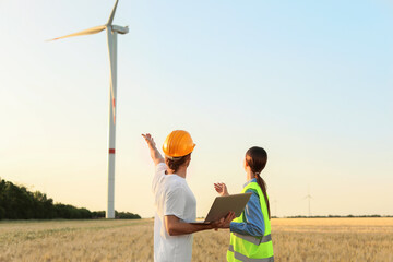 Canvas Print - Engineers on windmill farm for electric power production